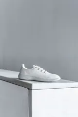 Zapatilla de diseño minimalista confeccionada en lana merino, con cordones al tono y suela de EVA. Presenta un estilo atemporal y versátil, ideal para uso diario.