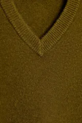 Jersey de punto negro, con cuello en V (pico) y manga larga, acabado en rib en puños, cuello y bajo.