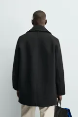 Chaquetón de corte regular confeccionado en tejido con lana. Presenta cuello con solapas anchas de muesca, manga larga, cierre frontal de botonadura cruzada, bolsillos de vivo en el pecho y bolsillos de solapa en la cadera.