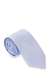 Corbata morada con pequeños lunares blancos.