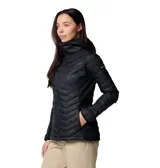 Chaqueta híbrida para mujer, con cuerpo acolchado con aislamiento sintético y paneles laterales elásticos. Presenta cierre frontal completo, cuello alto con protección para la barbilla, bolsillos laterales con cierre y dobladillo ajustable.