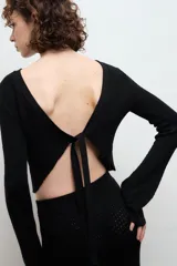 Blusa color crema de punto 100% algodón, con cuello redondo y mangas largas acampanadas.