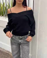 Sweater de punto color negro, con escote estilo bardot y mangas largas. Presenta un diseño acanalado y corte ajustado.