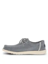 Alpargata Hush Puppies modelo Canyon, color gris con textura tejida. Presenta cordones decorativos y suela de EVA en color crema, diseñada con tecnología ZeroG para mayor ligereza y flexibilidad.