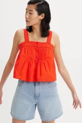 Musculosa de corte holgado con escote cuadrado, tirantes anchos y cierre frontal con botones. Presenta detalles de encaje en el escote y costuras plisadas en el frente.