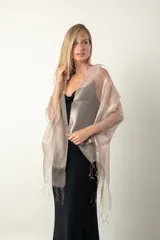 Chal de organza con tejido de lurex brillante, diseño ligero y traslúcido con terminación de flecos en los extremos.