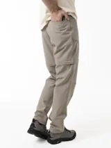 Pantalón técnico Merrell de trekking, color beige, desmontable con cierre para convertirlo en bermuda. Posee cintura con cinturón ajustable y bolsillos con cierre.