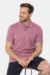 Remera polo de piqué color malva, de manga corta, con cuello y tapeta de botones en el mismo tono.