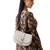 Cartera tipo saddle bag Guess modelo Carrie, color beige, con diseño estructurado, solapa frontal con cierre magnético y logo metálico. Incluye una correa de cadena con detalles en cuero sintético y una correa adicional ajustable y extraíble.