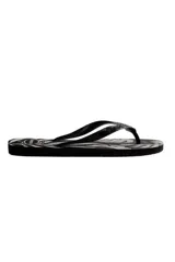 Chancletas Havaianas modelo Aloha en color beige con estampado tropical de hojas en negro y tiras finas texturizadas.