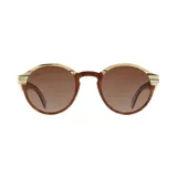 Lentes de sol Indie modelo Hill con montura redonda de madera clara y marrón, y lentes marrones degradados.