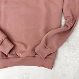 Buzo color rosa viejo de algodón con cuello redondo, puños y cintura acanalados. Estampa frontal con el texto "DUXON JEANS LOS ANGELES EST. 1982" en color blanco.