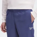 Pantalón deportivo Reebok Classics Vector azul con cintura elástica y cordones ajustables.