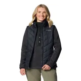 Chaleco Columbia Heavenly II de color negro, con diseño acolchado y tecnología termorreflectante Omni-Heat. Cuenta con cierre frontal de dos vías, cuello alto forrado y bolsillos laterales con cierre.