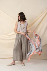 Pañuelo cuadrado de seda con estampado abstracto en degrade de colores azul, amarillo, blanco y rosa, con borde naranja.