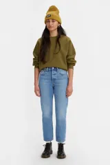 Jean de corte recto y estilo cropped, confeccionado en denim de algodón rígido. Presenta un lavado azul medio con efecto desgastado, tiro medio y cierre de botones clásico de la línea 501.