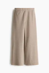 Pantalón de tiro alto con cintura elástica y piernas amplias, confeccionado en punto jacquard con diseño de cuadros pequeños.