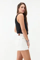 Short de denim blanco de tiro medio, con costuras pespuntadas en contraste y terminación desmechada en el ruedo.
