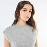 Chaleco de punto cálido color gris melange, con cuello redondo y diseño sin mangas.