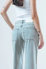 Pantalón de jean estilo wide leg, color celeste claro, con costuras verticales decorativas en el frente y corte amplio desde la cadera hasta el ruedo.
