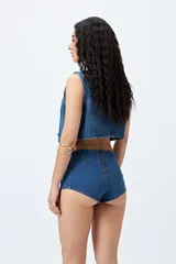 Microshort de tiro bajo color negro, con cierre metálico en la espalda, de calce ajustado y largo mini.