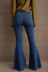 Jean de corte oxford con tiro medio-alto, ajustado en muslos y con ensanche pronunciado desde la rodilla. Presenta costura horizontal a la altura de la rodilla y tajos laterales en el ruedo.