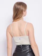 Top sin mangas color turquesa, de textura acanalada y brillante.