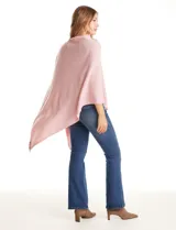 Poncho tejido de punto con diseño asimétrico y aberturas laterales para los brazos.