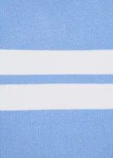 Remera de tejido de punto fino con cuello redondo y mangas cortas. Presenta un diseño recto con franjas horizontales blancas en la parte superior sobre un fondo celeste.