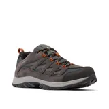 Championes de trekking Columbia modelo Crestwood Waterproof, color gris grafito con detalles en naranja. Presentan una construcción impermeable con tecnología Omni-Tech, entresuela TechLite para amortiguación y suela Omni-Grip para tracción en diversos terrenos.