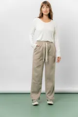 Pantalon deportivo de corte wide leg con caída relajada, confeccionado en tejido frizado con interior suave. Cuenta con cintura elastizada con cordón ajustable y bolsillos laterales.