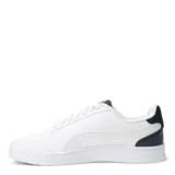 Championes Puma modelo Shuffle, de diseño urbano con silueta de bota baja. Presentan una parte superior de cuero sintético negro con la icónica franja lateral blanca y detalles en dorado. Incluyen perforaciones en la puntera para mayor ventilación y una suela de goma blanca.