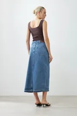 Falda larga de jean azul con abertura frontal y ruedo desflecado.