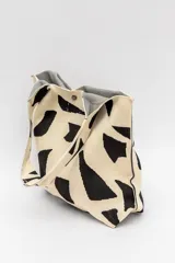 Bolso tipo tote bag con estampado de cebra en tonos beige y negro, con asas de hombro.