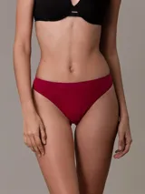 Colaless de microfibra elástica color rojo oscuro, con acabado sin costuras y logotipo de Calvin Klein en relieve en la cintura.