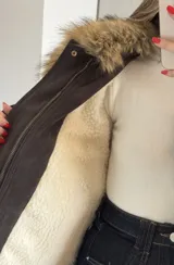 Campera tipo bomber de gamuza en color tostado, con diseño holgado, mangas amplias y cierre frontal con solapa.