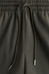 Pantalón deportivo de felpa de mezcla de algodón, color verde oscuro, de tiro alto con cordón ajustable en la cintura y puños elásticos en los bajos.