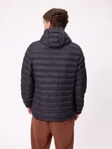 Campera puffer negra con capucha, cierre frontal completo y bolsillos laterales con cierre. Diseño acolchado horizontal con logo de la marca en el pecho.