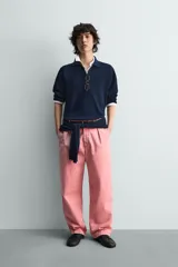 Jersey de punto color azul marino, de corte relajado, con cuello solapa y cierre frontal de tres botones. Presenta mangas largas y acabados en rib en puños y bajo.