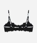 Top de bikini negro con textura acanalada, breteles finos y estampado geométrico en el contorno.