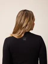Remera de manga larga con cuello tortuga, confeccionada en tejido de algodón con elastano, de corte ajustado al cuerpo y diseño liso.