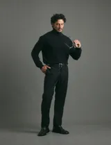 Polera de punto de manga larga en color azul marino, con cuello alto doblado y puños y ruedo acanalados.