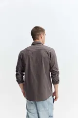 Camisa de manga larga color gris oscuro, confeccionada en tejido liviano con textura sutil, cuello tradicional y cierre frontal de botones.