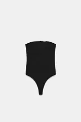 Body strapless de corte ajustado, confeccionado en tejido de poliamida, con cierre inferior mediante botones a presión.