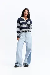 Buzo de tejido liviano con diseño de rayas horizontales en azul marino y gris, cuello tipo polo en color crema y mangas largas.