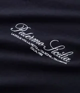 Remera masculina negra de algodón, con corte boxy, mangas cortas y cuello redondo. Presenta un lettering bordado en blanco en la parte delantera con la frase "Palermo Sicilia".