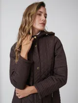 Campera matelassé color marrón con diseño combinado de rombos en el cuerpo y costuras horizontales en las mangas. Cuenta con capucha fija, cierre frontal oculto bajo solapa con botones a presión dorados y ajuste entallado en la cintura.