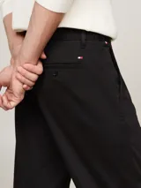 Pantalón chino negro de corte cónico, confeccionado en satén de algodón elástico.