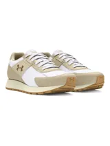 Championes Under Armour de estilo retro, confeccionados con una combinación de nailon ligero y revestimientos de gamuza. Presentan un diseño en tonos blanco y beige, con el logo de la marca en el lateral y suela de goma dentada para mayor tracción.