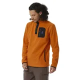 Canguro color naranja de polar fleece con cuello alto con cierre de botones a presión, bolsillo en el pecho con cierre y logo de la marca.